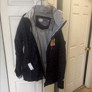 686 Black Ski Jacket with Light Gray Interior and Subtle Dot Pattern